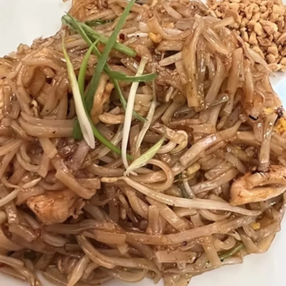 Charm Thai Cuisine's Pad See Ew with wide rice noodles, chicken, and green onions.