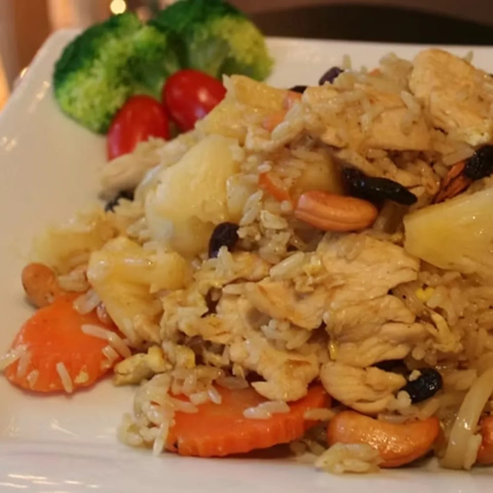 Charm Thai Cuisine's pineapple fried rice with chicken, cashews, raisins, carrots, and broccoli.