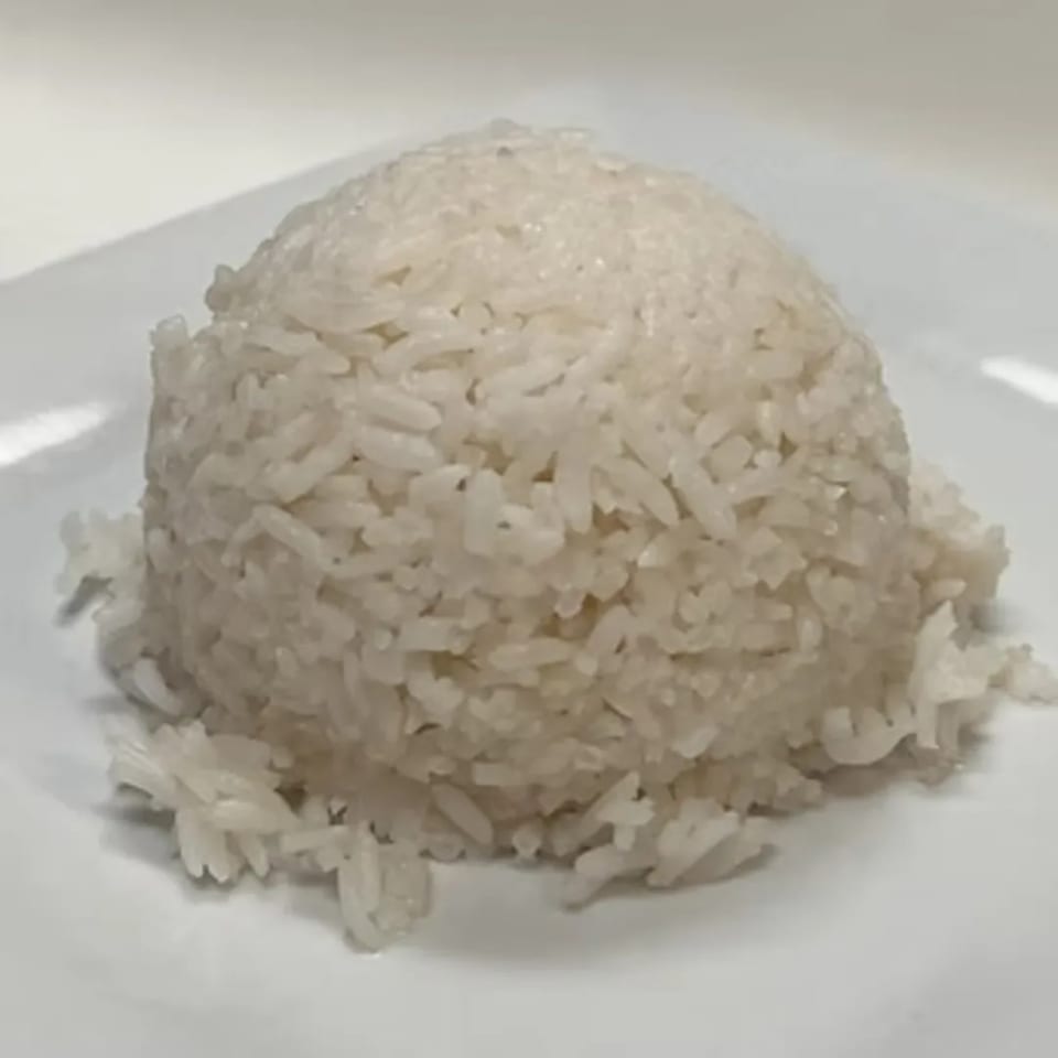 A mound of fluffy white rice, a staple side dish at Charm Thai Cuisine.