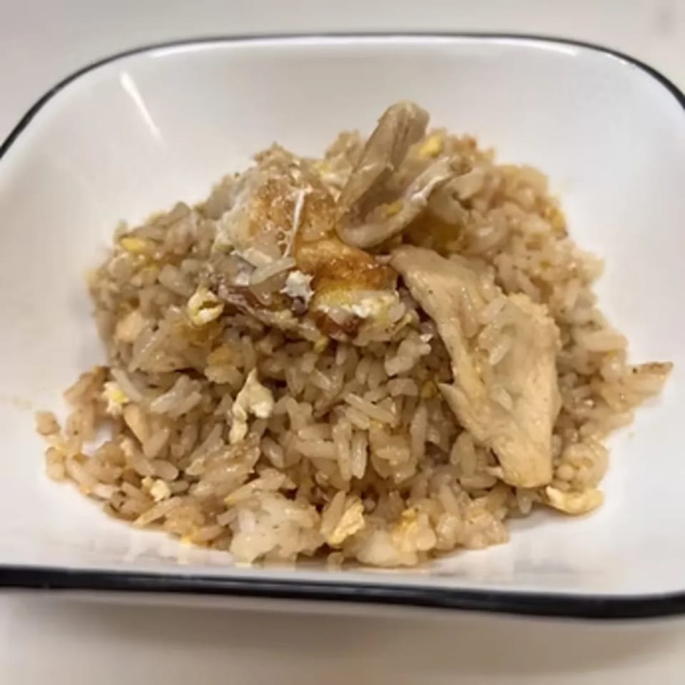 Close-up of Charm Thai Cuisine's fried rice with chicken and egg in a white bowl.
