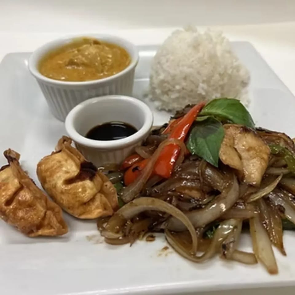 Charm Thai Cuisine's stir-fried chicken with onions, peppers, basil, rice, dumplings, and two sauces.