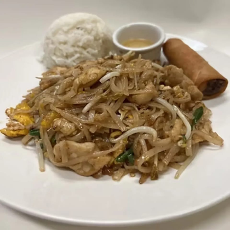 Charm Thai Cuisine's Pad Thai with chicken, bean sprouts, rice, and an egg roll on a white plate.