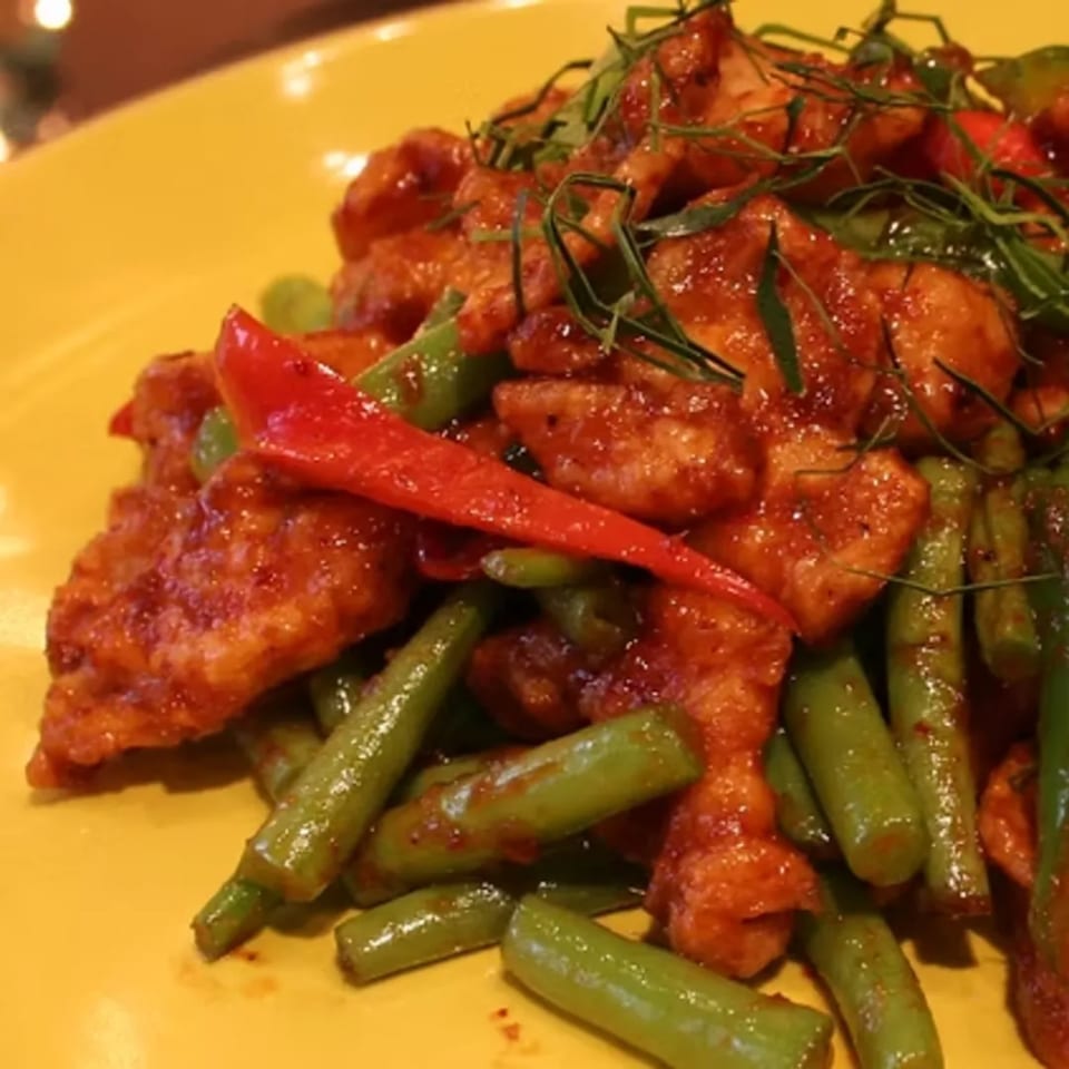 Charm Thai Cuisine's spicy red curry chicken with green beans, red peppers, and kaffir lime leaves.