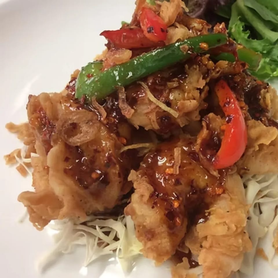 Crispy fried chicken or fish with sweet chili sauce, red and green peppers, and shredded cabbage.