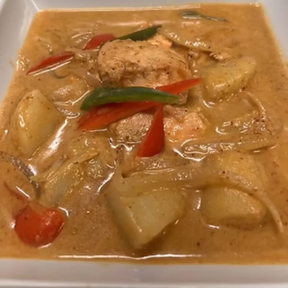 Charm Thai Cuisine's Massaman Curry with chicken, potatoes, onions, red and green bell peppers.