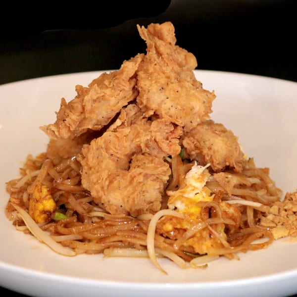 Charm Thai Cuisine's Pad Thai with crispy fried chicken, noodles, egg, and bean sprouts.
