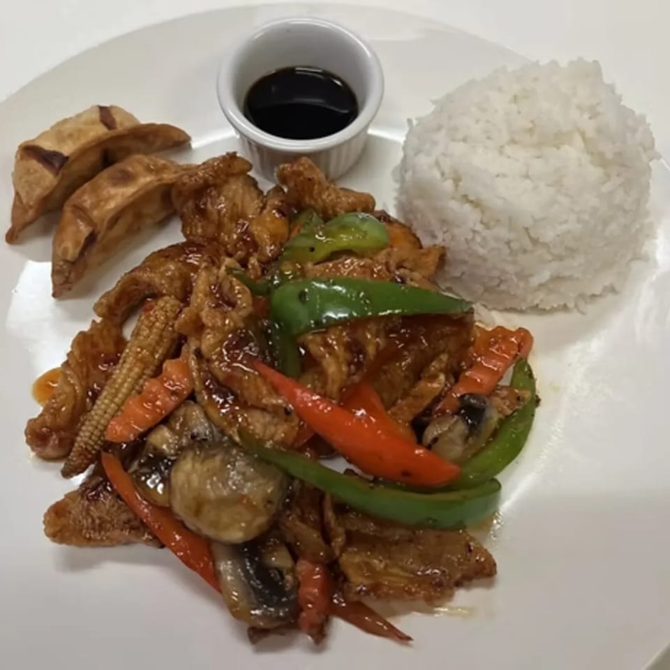 Charm Thai Cuisine's stir-fried chicken with vegetables, rice, dumplings, and soy sauce.