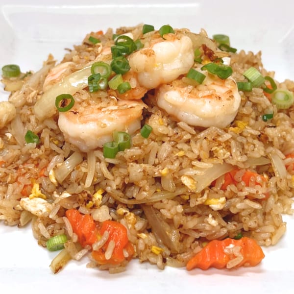 Shrimp fried rice with carrots, onions, and green onions, a dish from Charm Thai Cuisine.